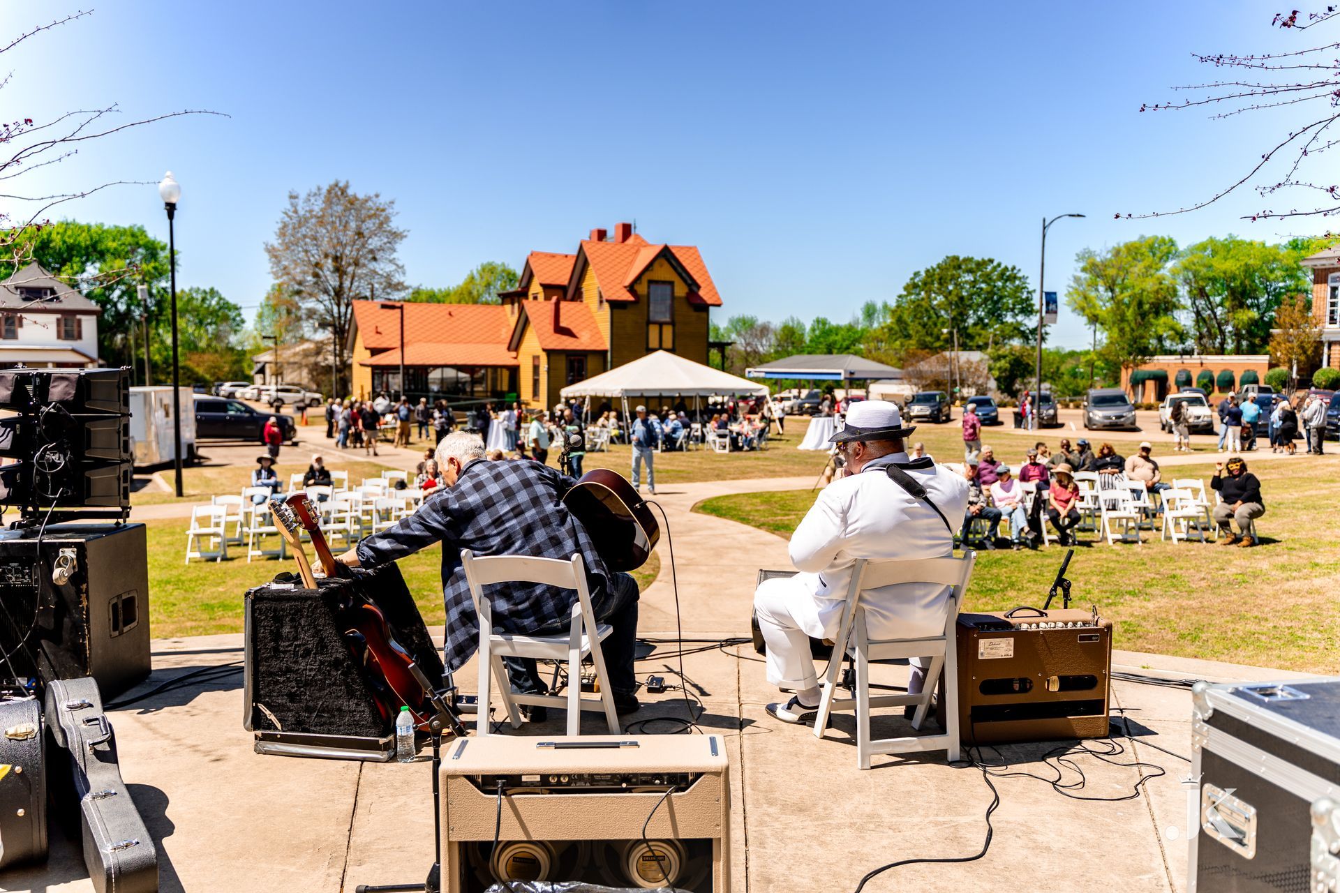 A group of men are playing instruments on a stage in front of a crowd.