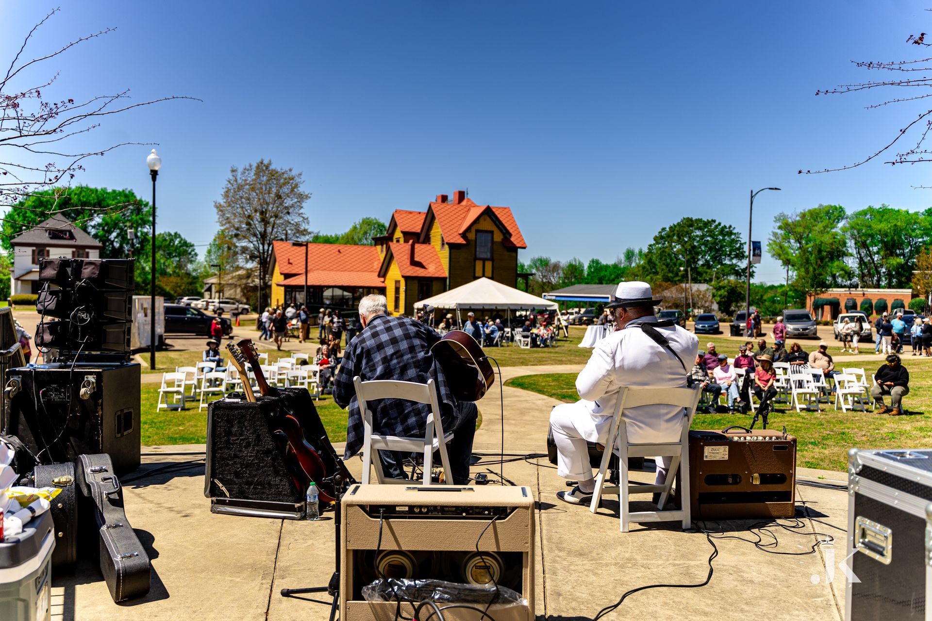 A group of men are playing instruments in a park.