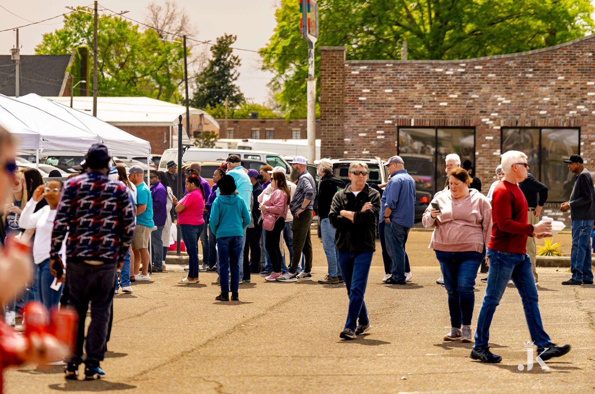 A large group of people are walking down a street.