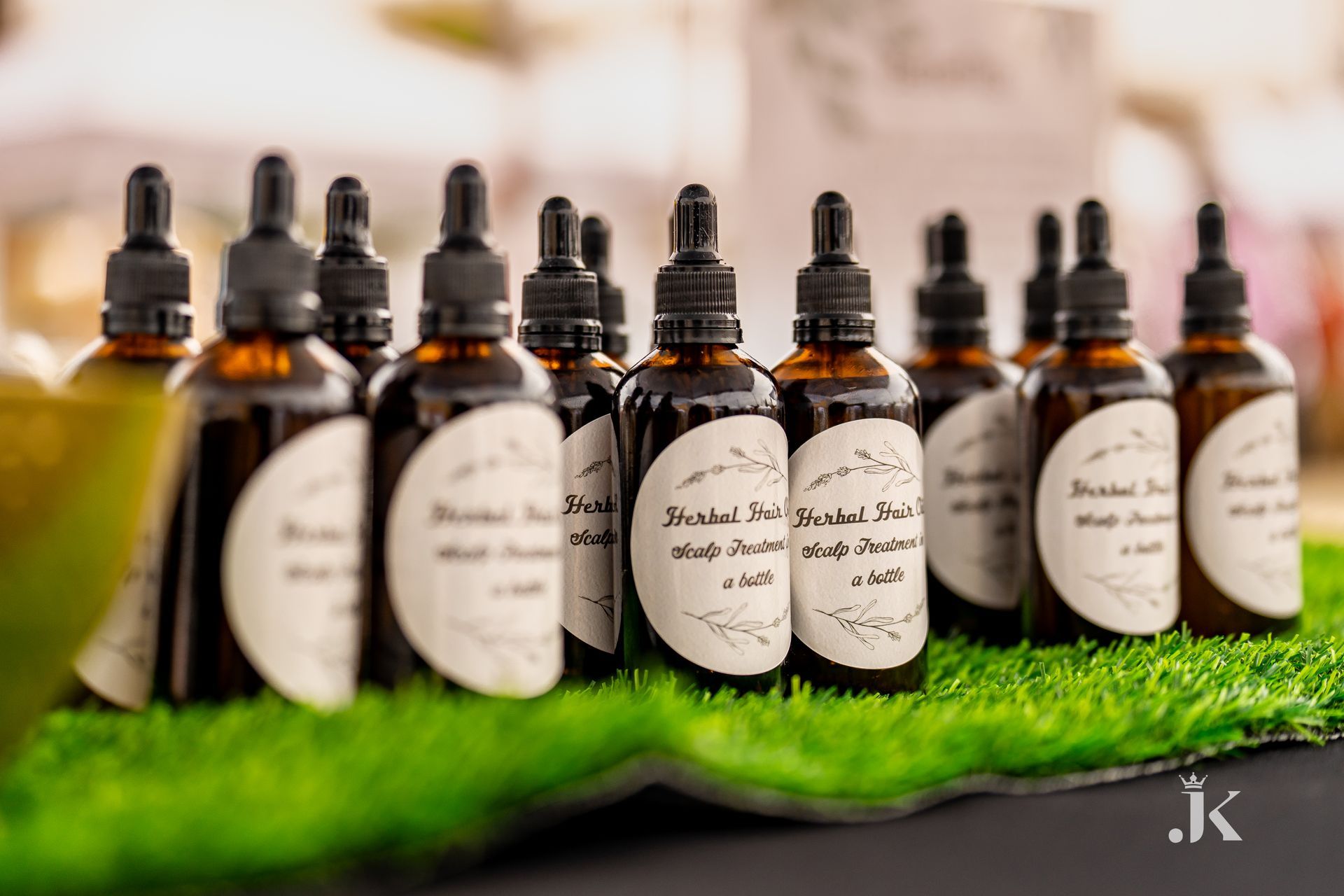 A row of bottles sitting on top of a lush green field.
