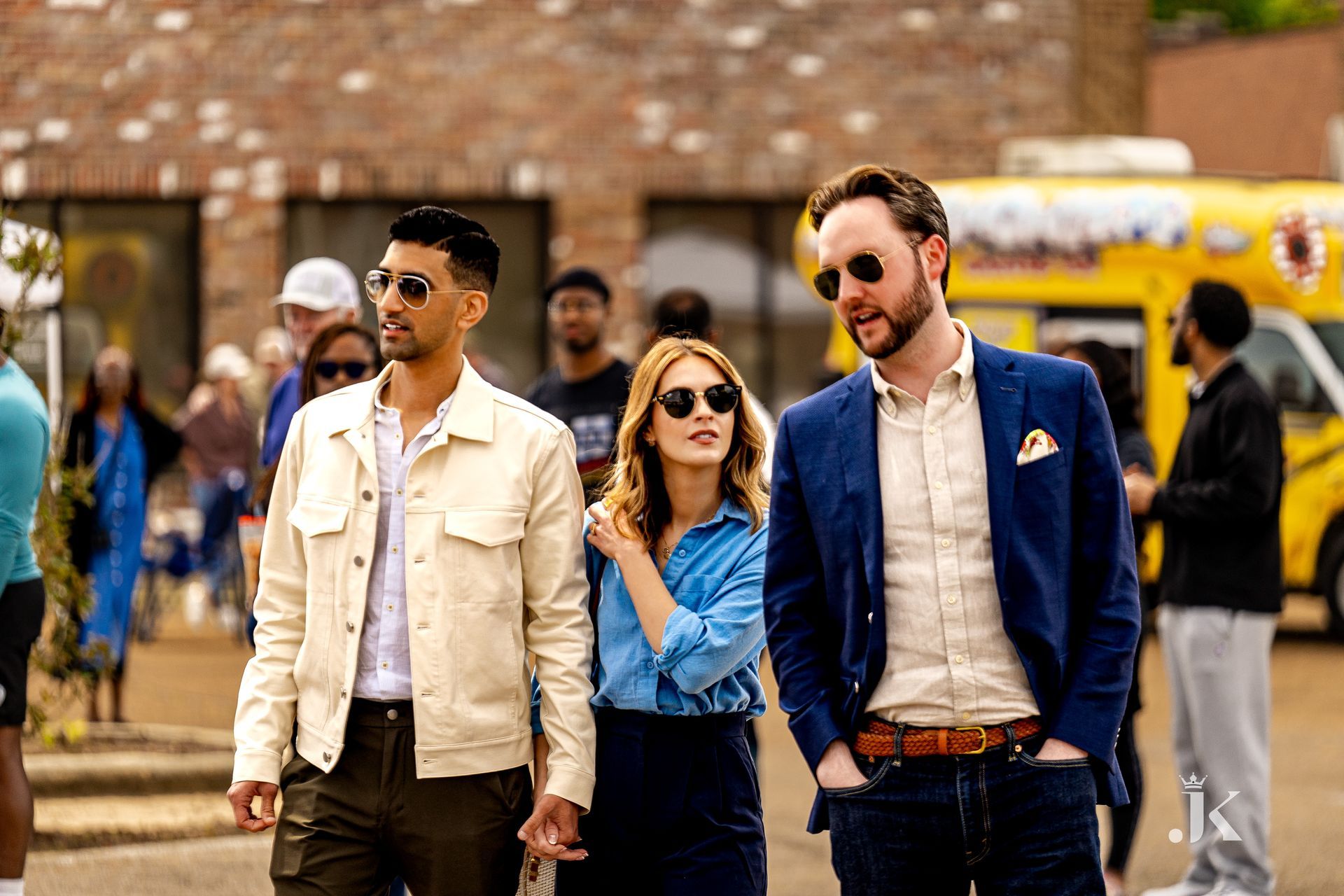 A group of people are walking down a street.