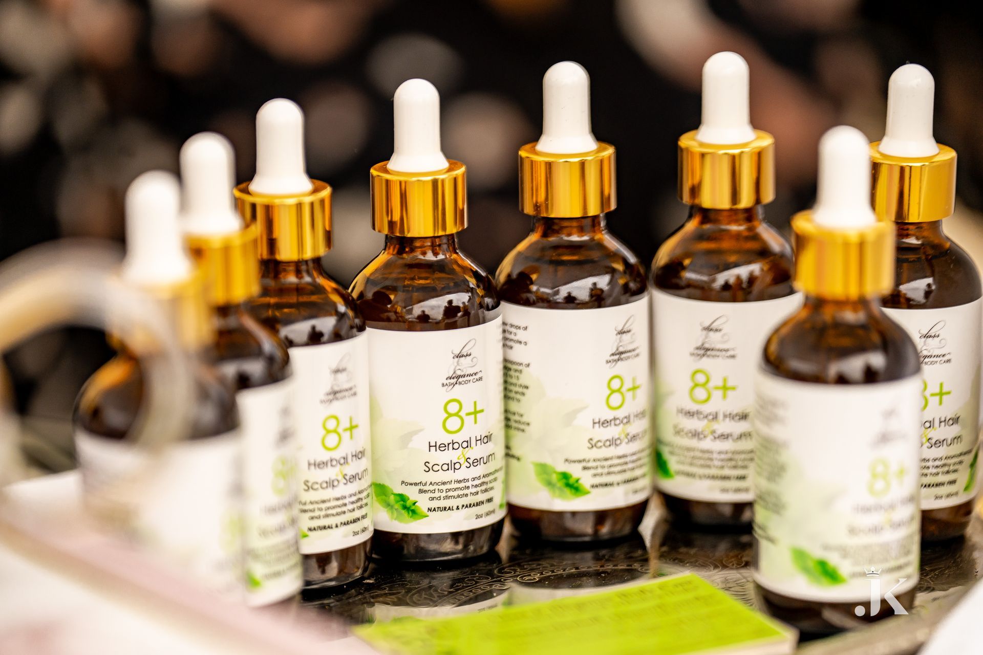 A bunch of bottles of serum are sitting on a table.