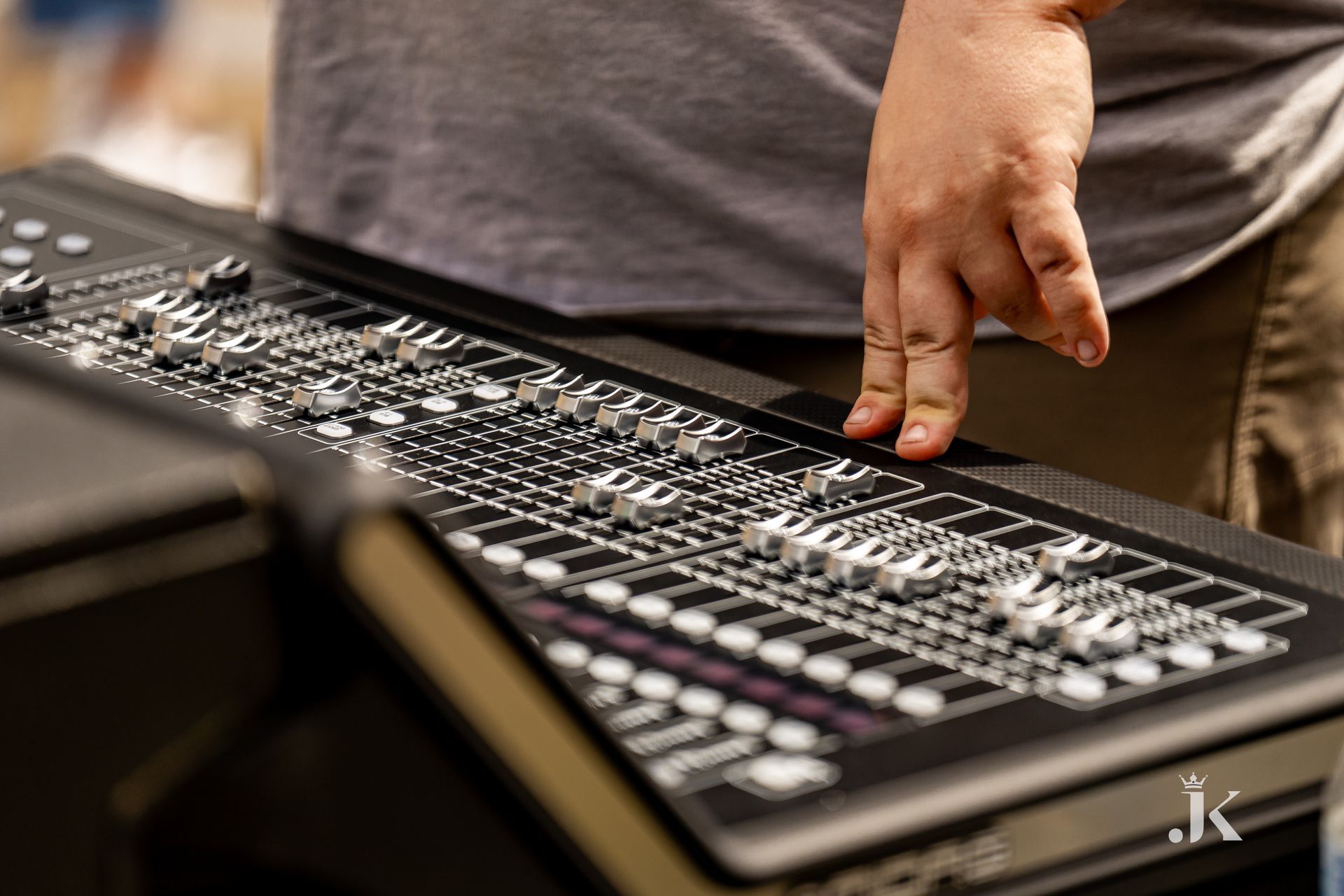 A person is pressing a button on a mixer with their finger.