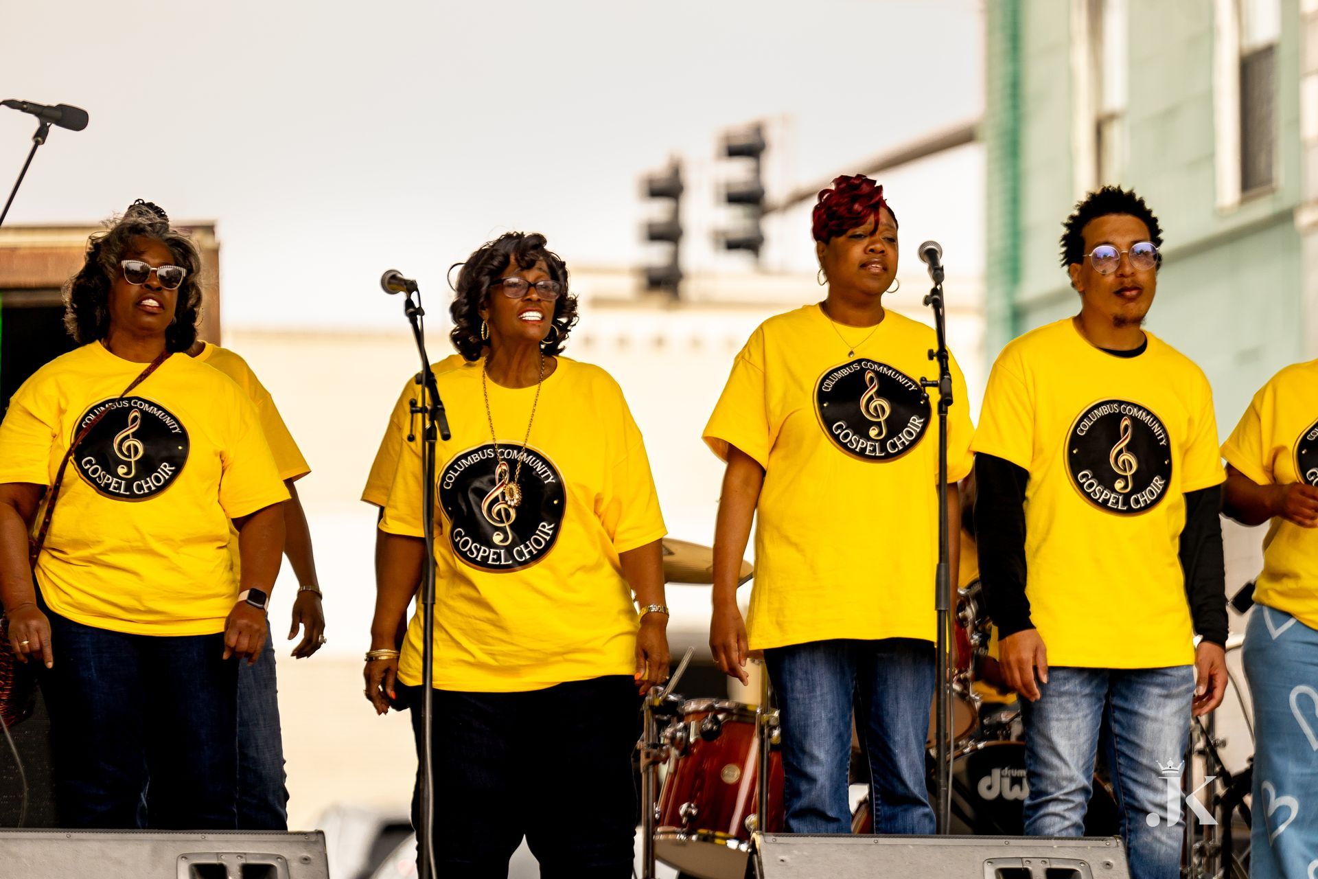 A group of people wearing yellow shirts with a treble clef on them