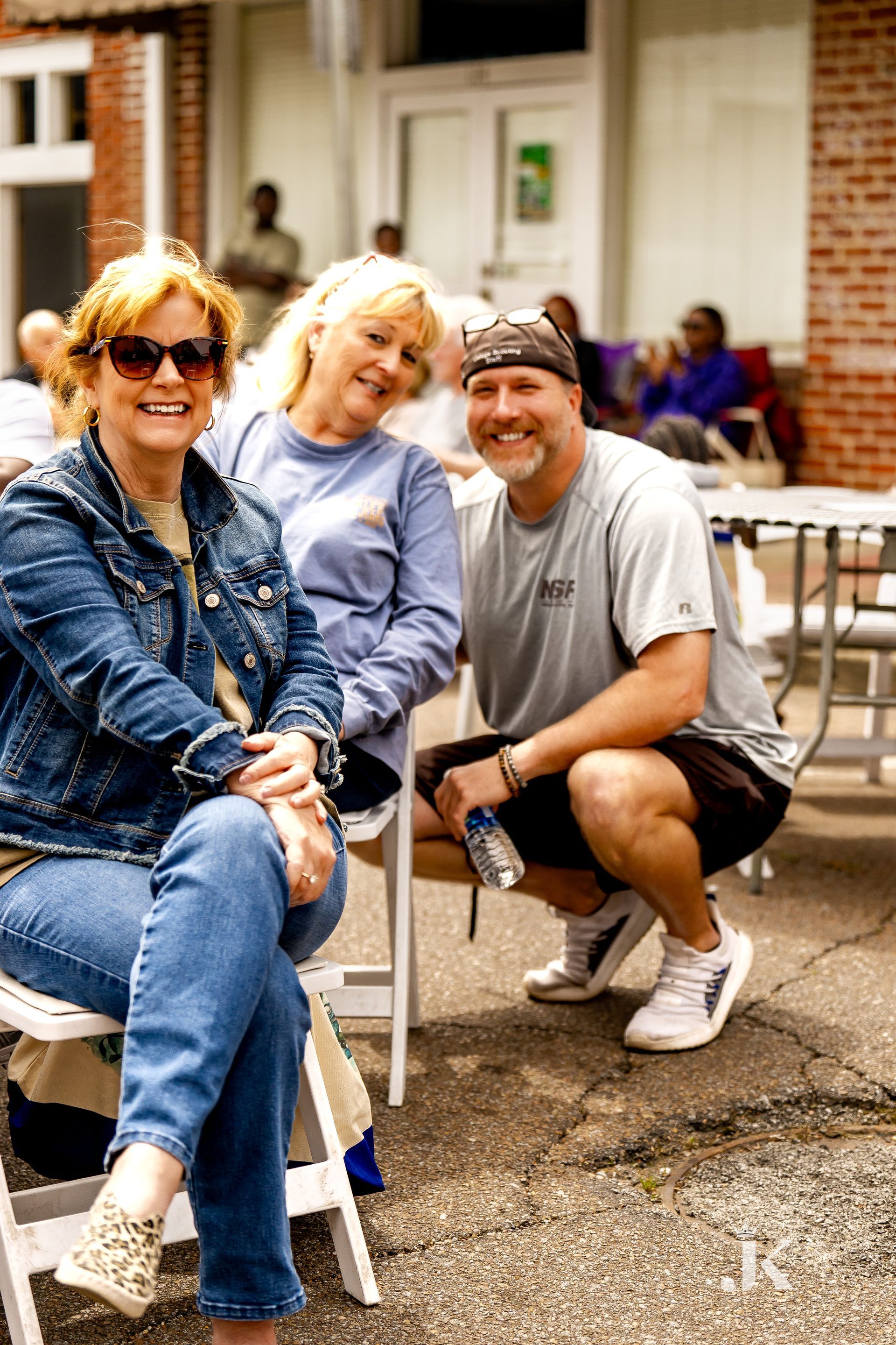 A group of people are sitting in chairs and posing for a picture.