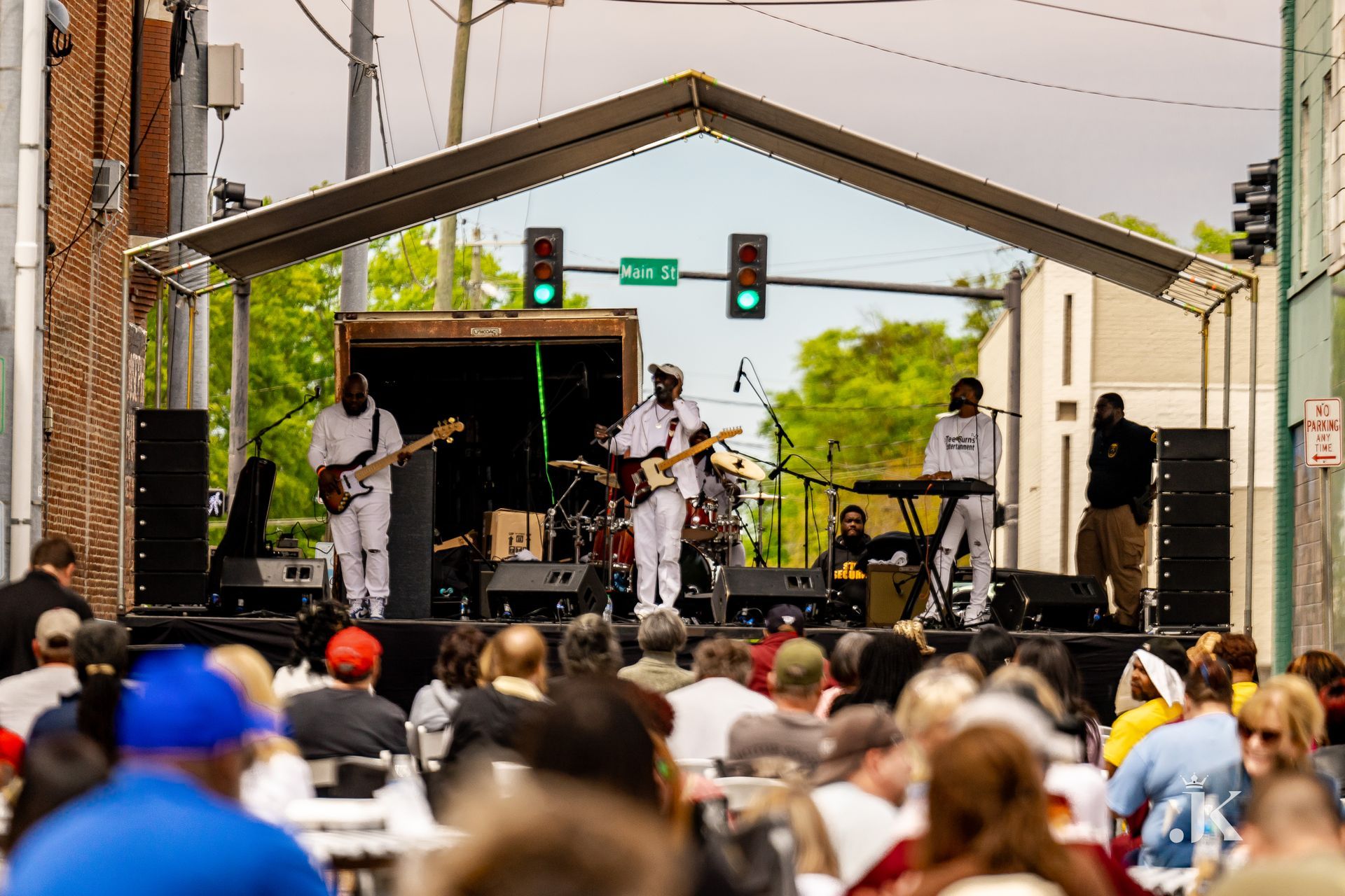 A band is playing on a stage in front of a crowd of people.