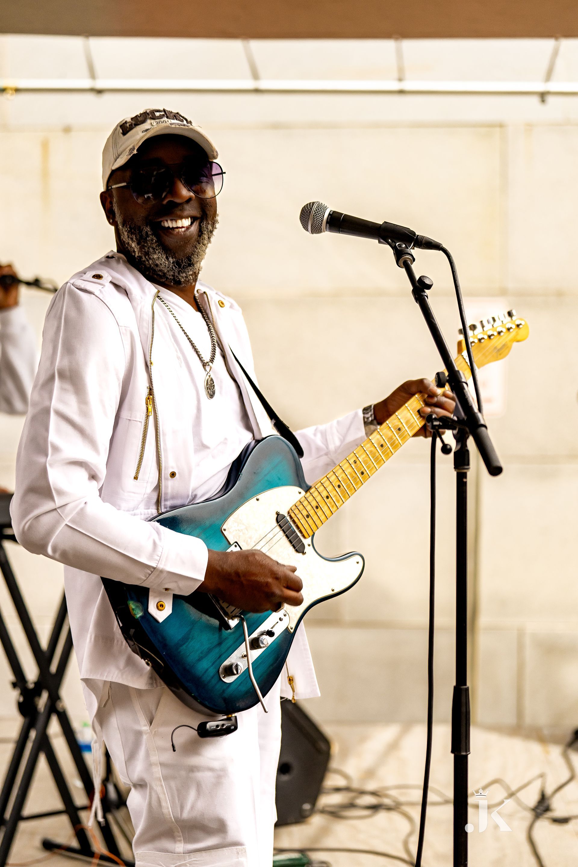 A man is playing a guitar and singing into a microphone.