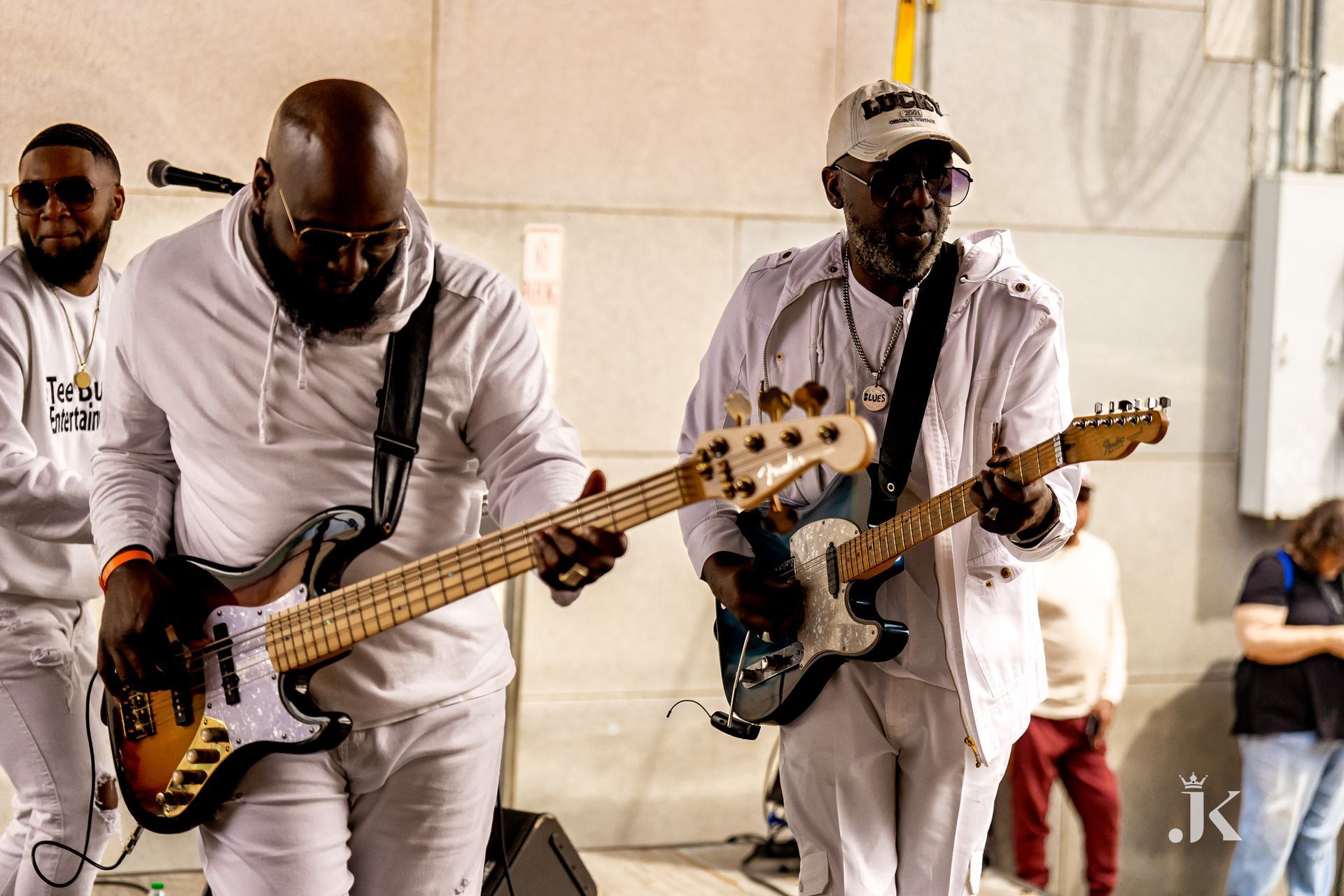A group of men are playing guitars on a stage.