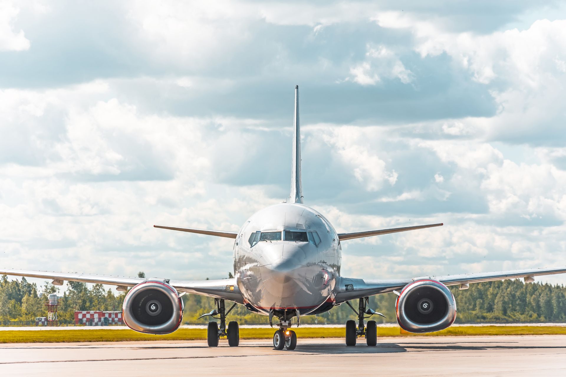 A large passenger jet is parked on the runway at an airport.