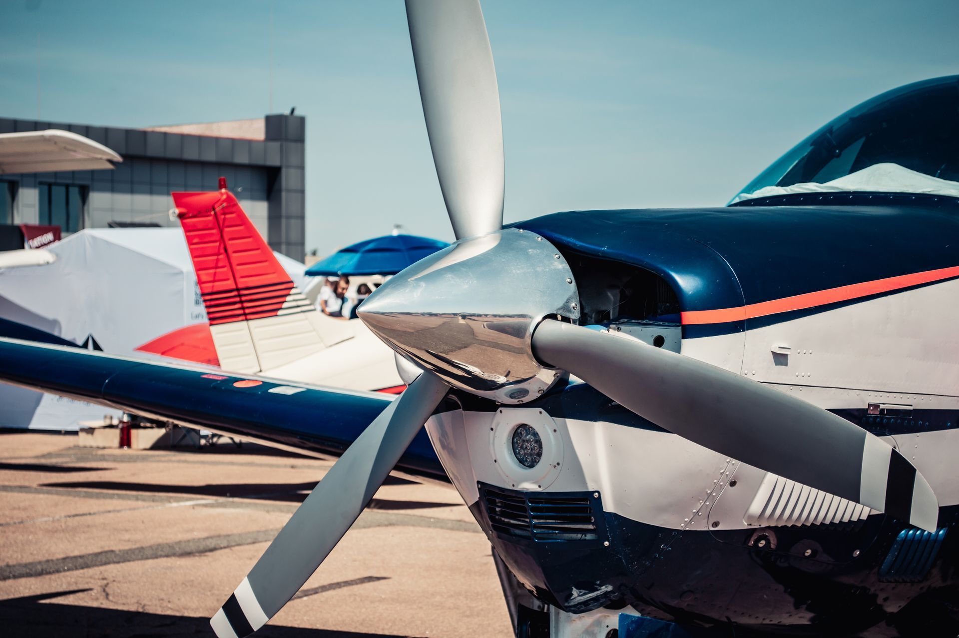 A small propeller plane is parked on a runway.