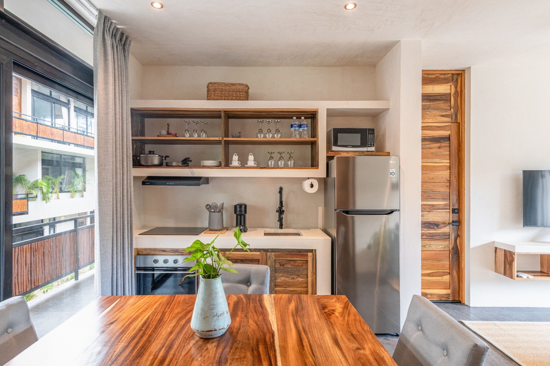 Kitchen and dining area to apartment with balcony