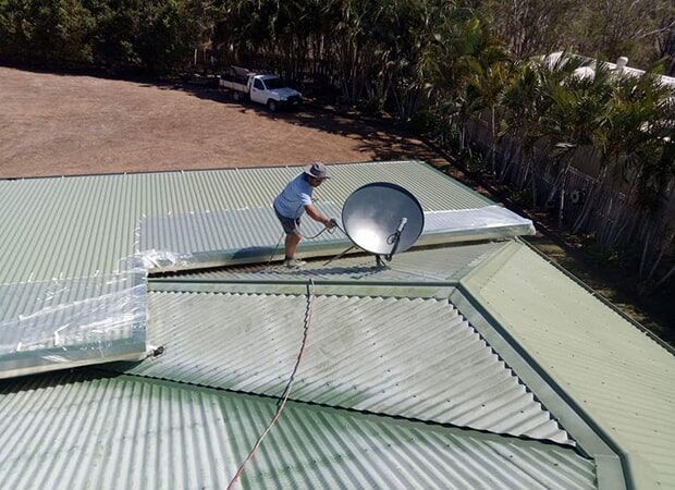Roof Technician Installing Antenna — Roof Restoration in Dundowran, QLD