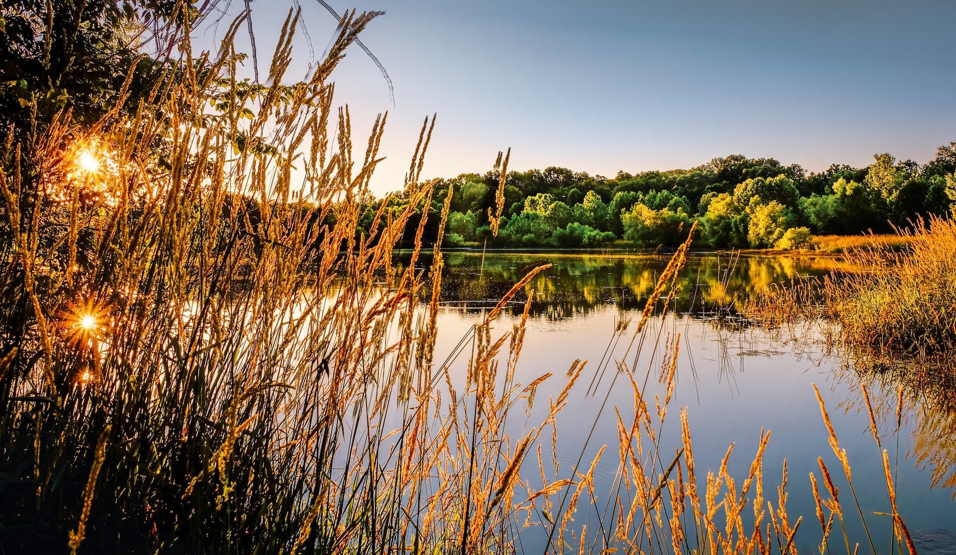 a large building with a clock tower and a fountain in front of it