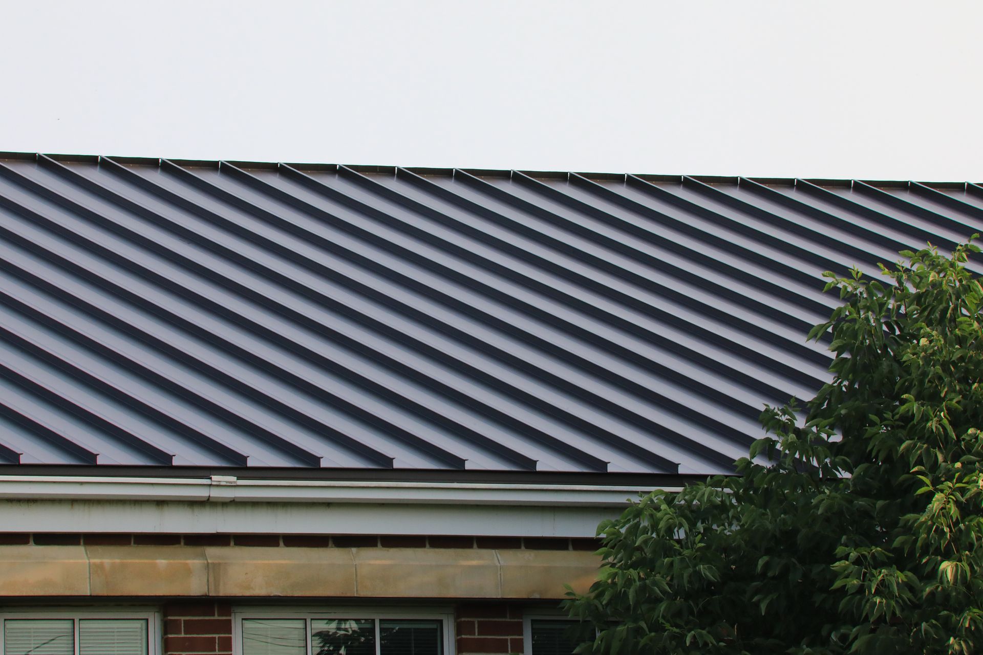 View of a metal roof showcasing expert craftsmanship, representing quality roofing services. 