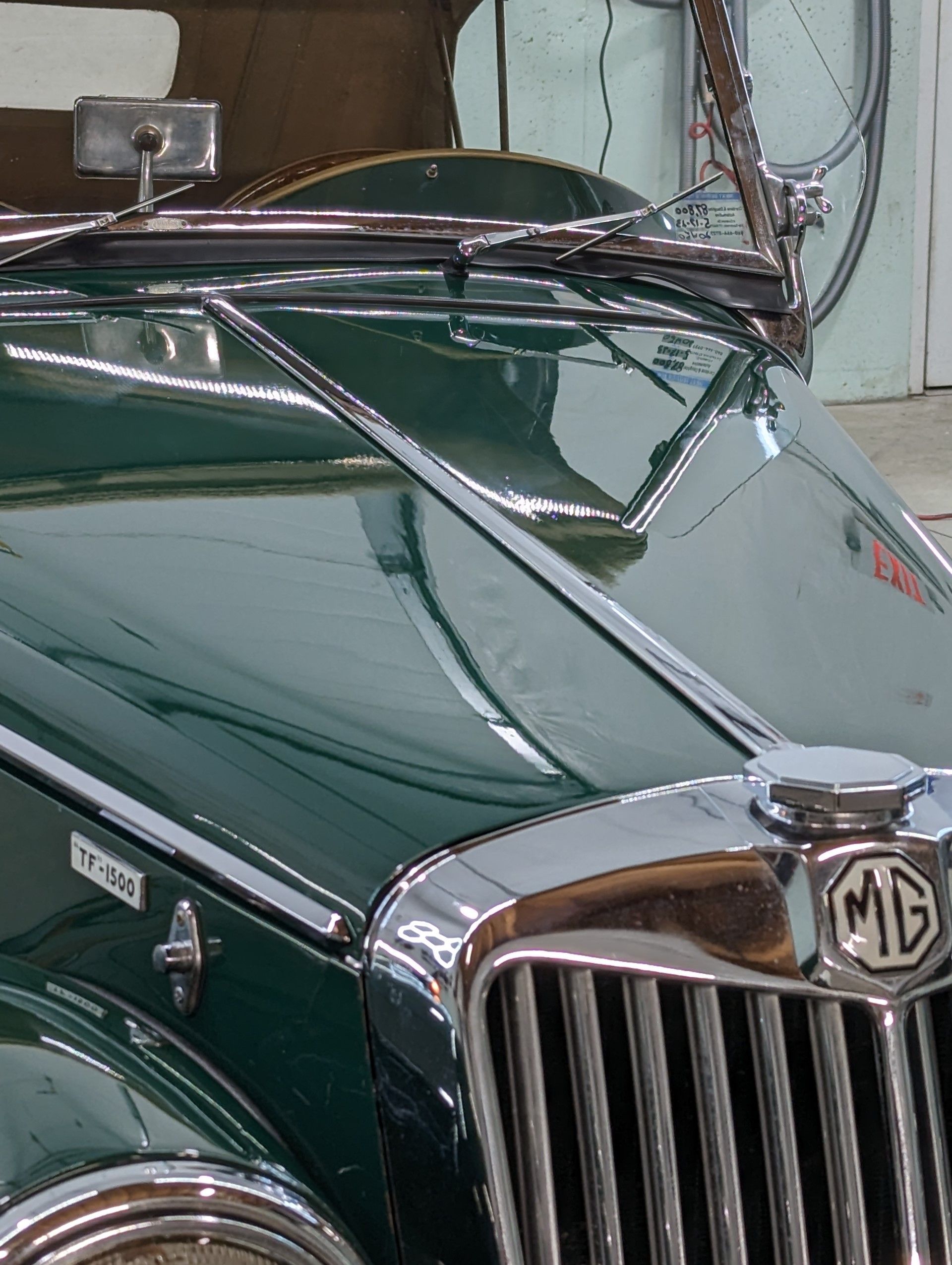Ceramic Coating - A green mg car is parked in a garage