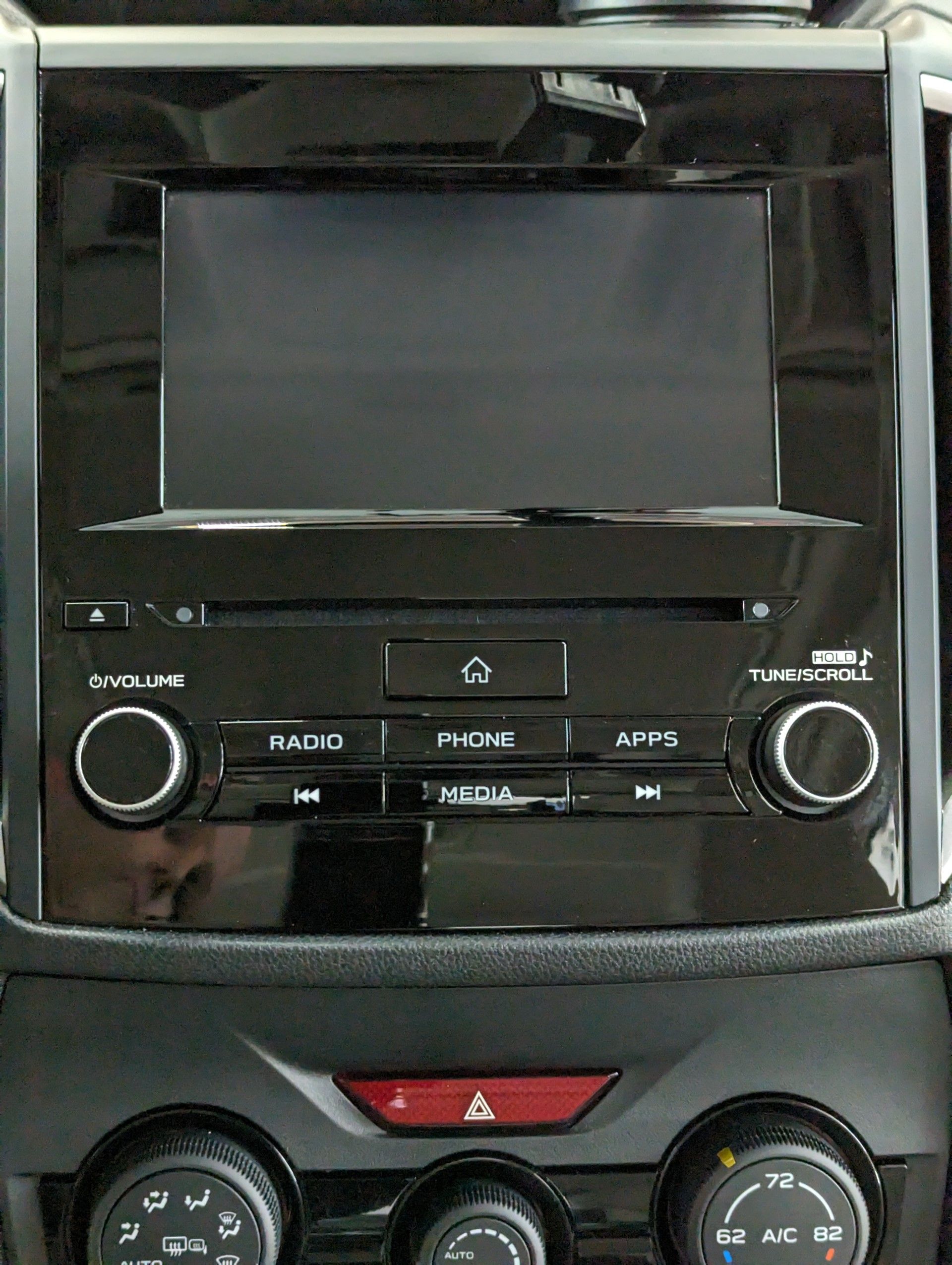 After Interior Detailing - A clean car radio with buttons for radio and phone