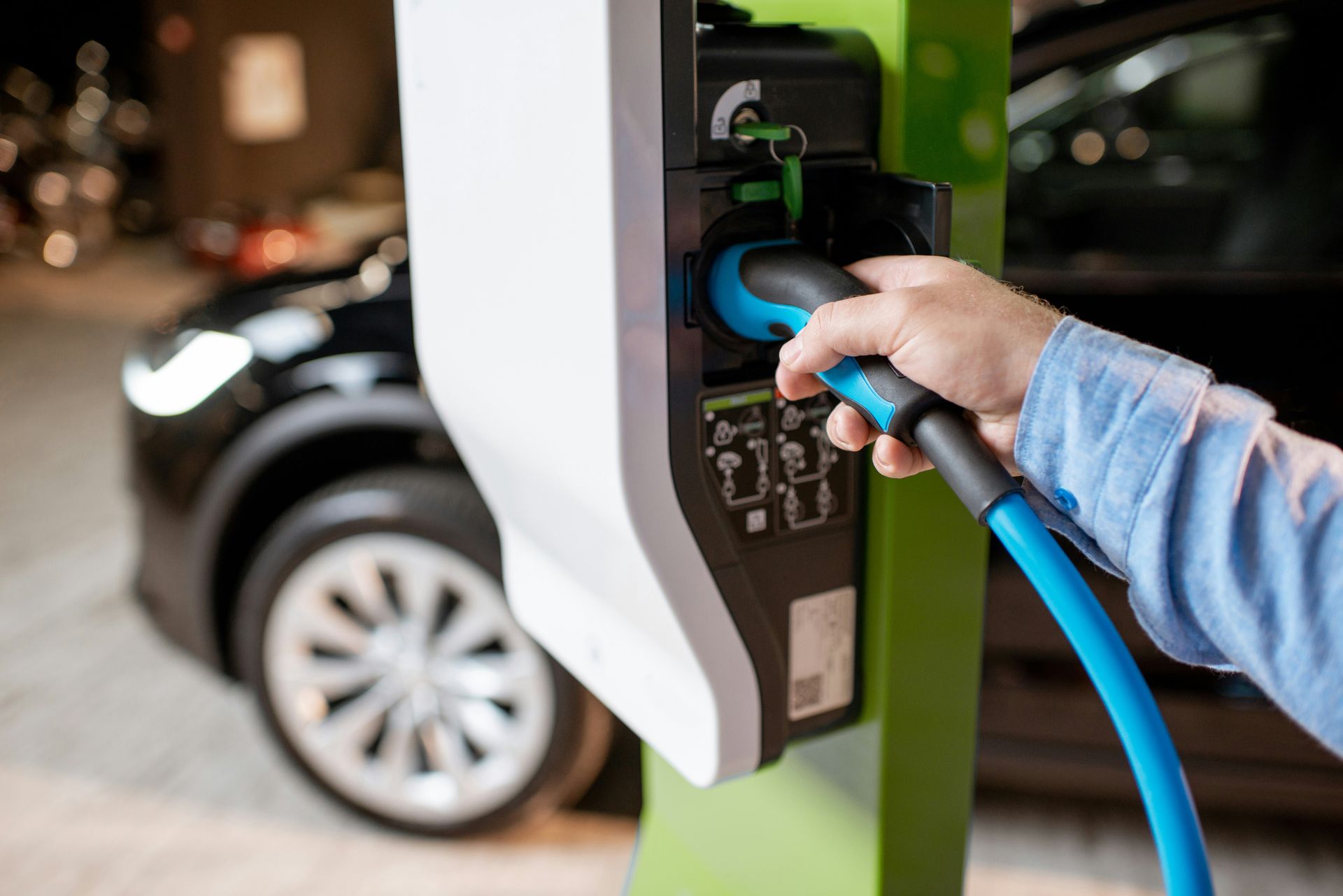 Home EV charging Austin, plugging a Level 2 charger into an electric vehicle on a dedicated circuit