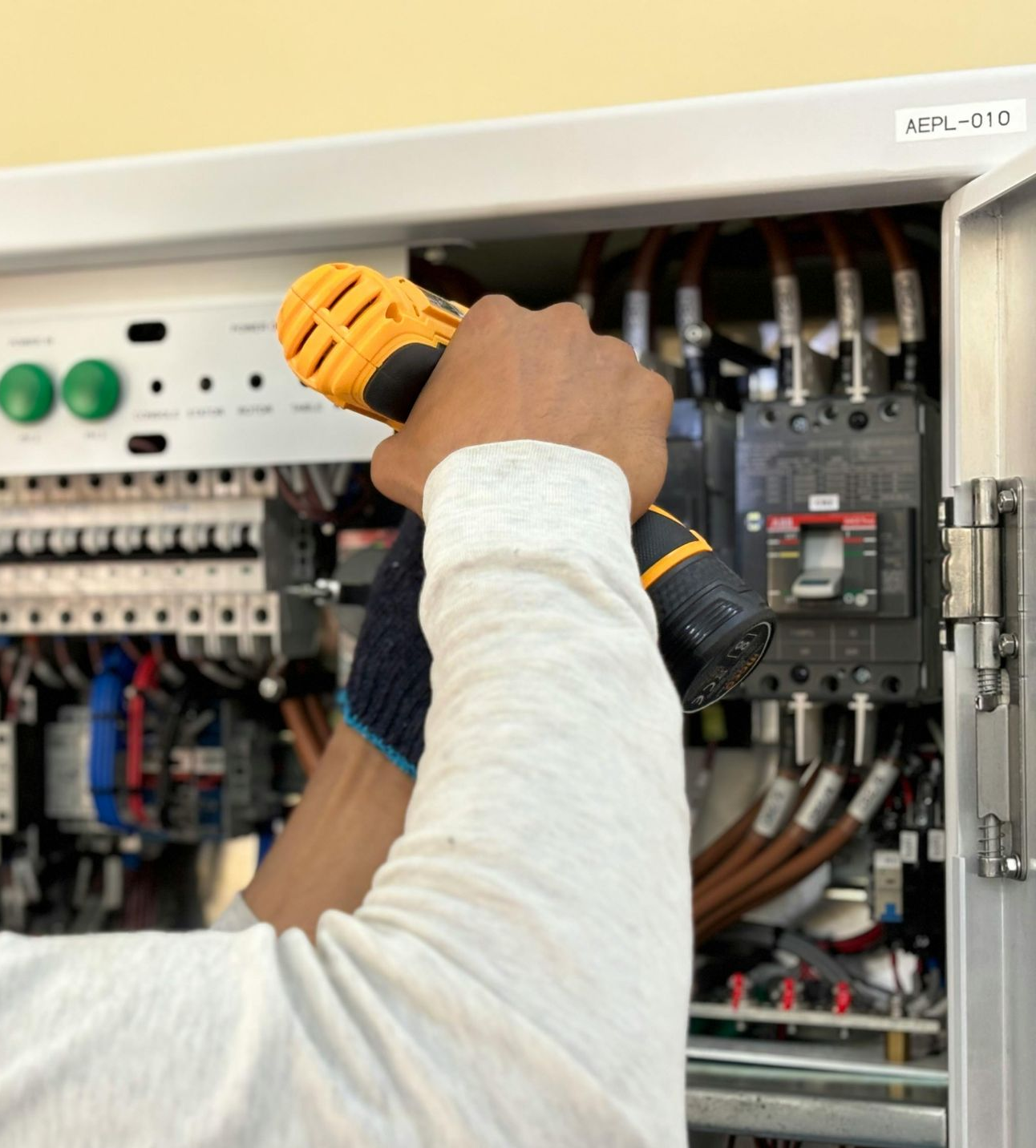 Breaker panel replacement Austin, electrician securing equipment with a power drill during an upgrade