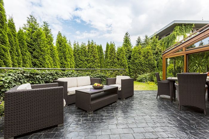 stamped concrete yard with couch and table