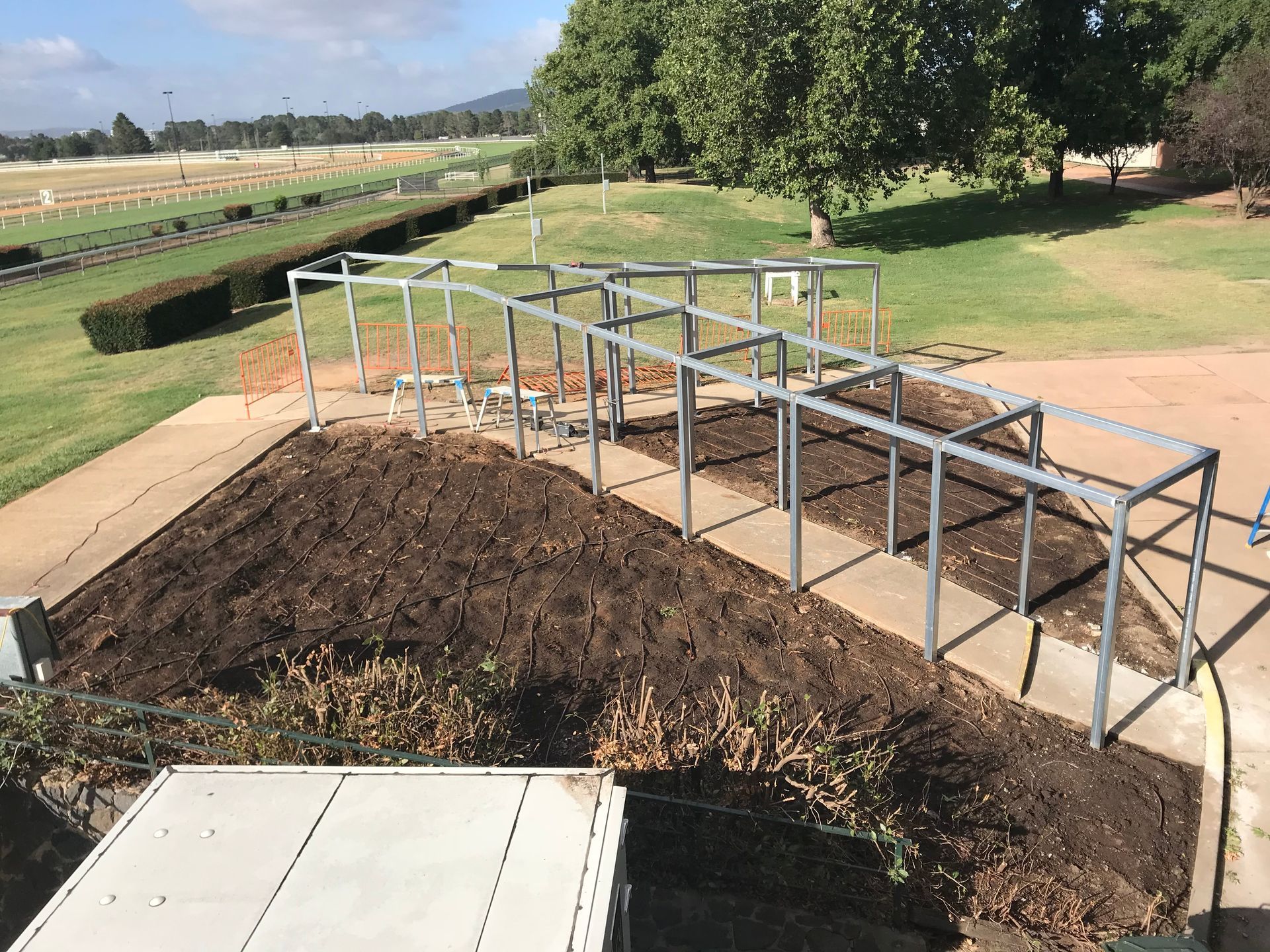 A metal structure is sitting on top of a dirt field — Magnum Steel In Crestwood, NSW