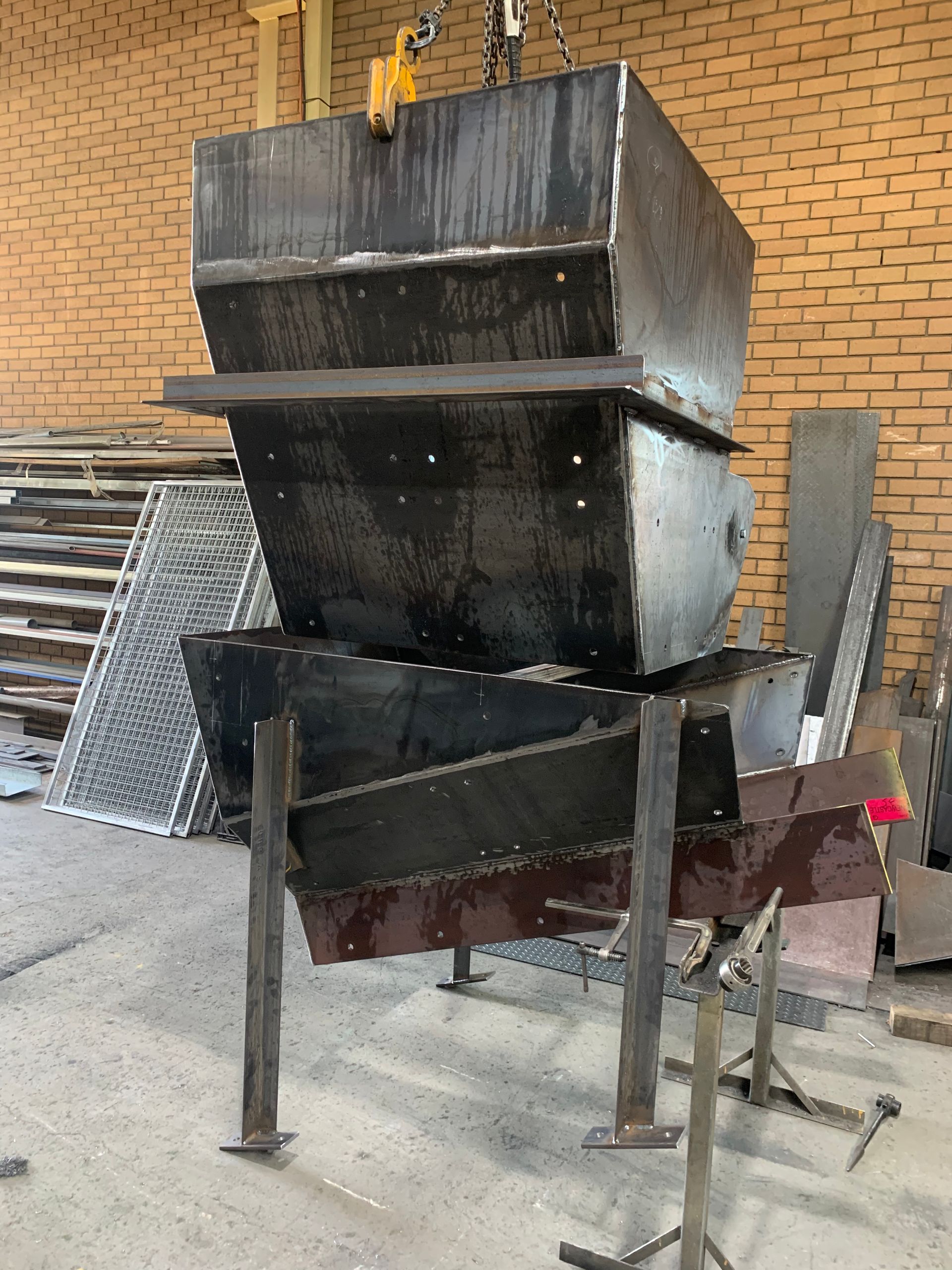 A stack of metal boxes sitting on top of each other in a warehouse — Magnum Steel In Crestwood, NSW