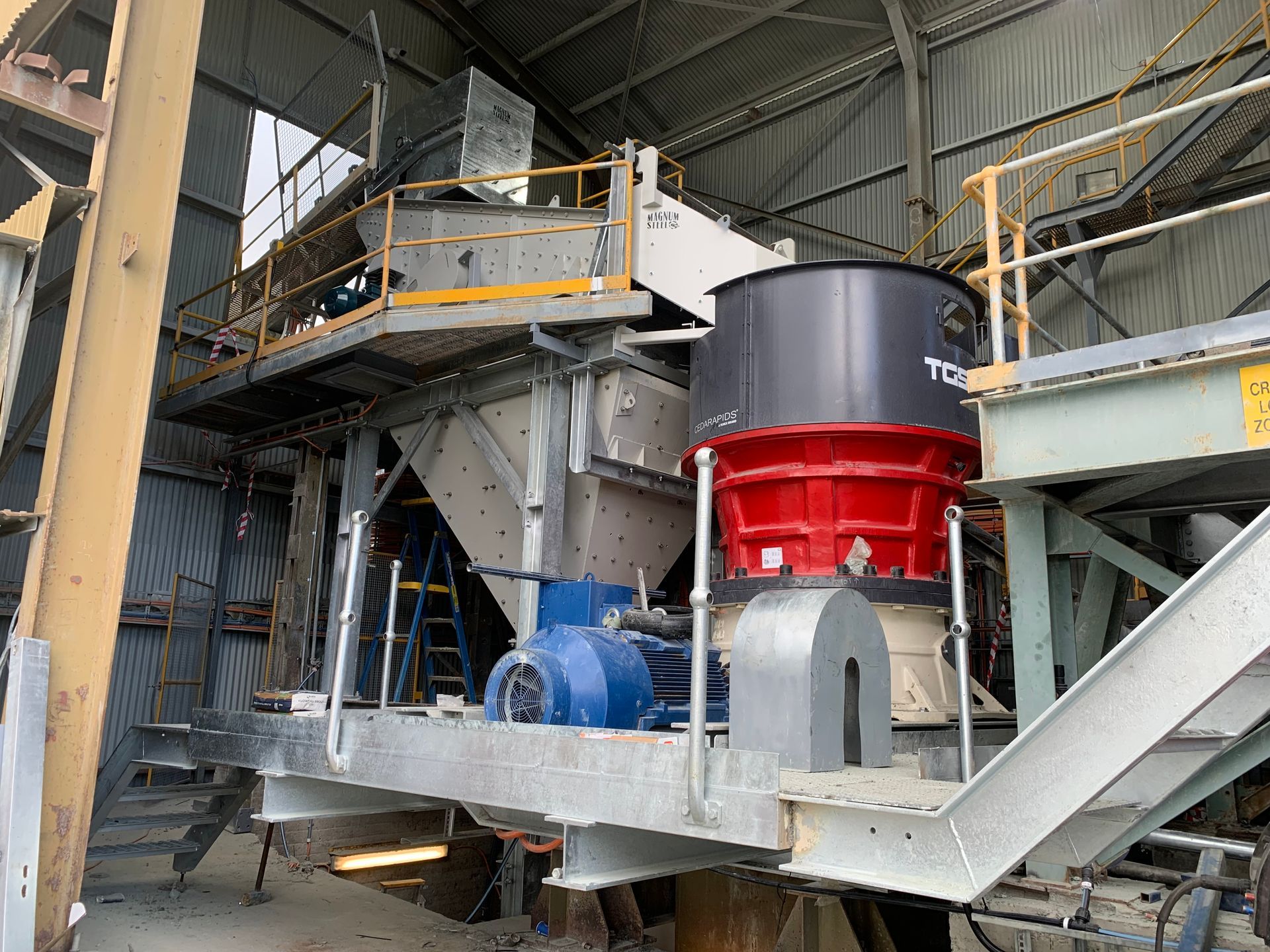 A large machine is sitting inside of a building in a factory — Magnum Steel In Crestwood, NSW