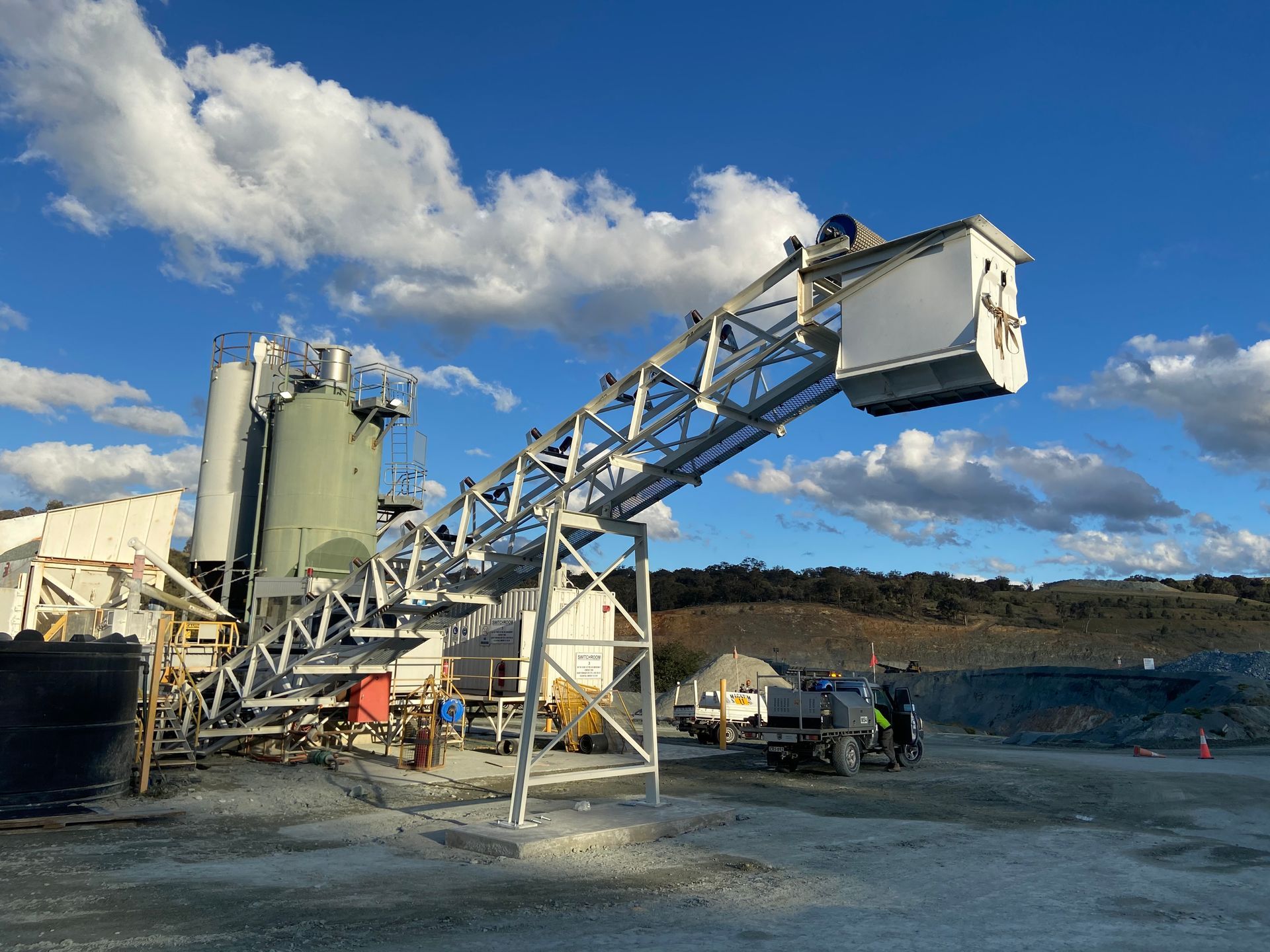 A concrete plant with a conveyor belt going through it — Magnum Steel In Crestwood, NSW