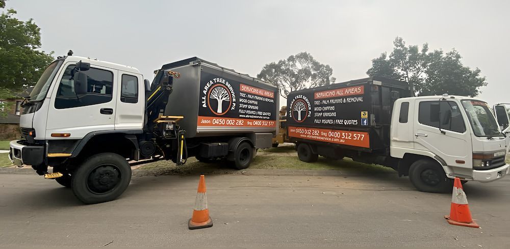Two Trucks Are Parked Next To Each Other On The Side Of The Road — All Area Tree Service Pty Ltd In Fountaindale, NSW