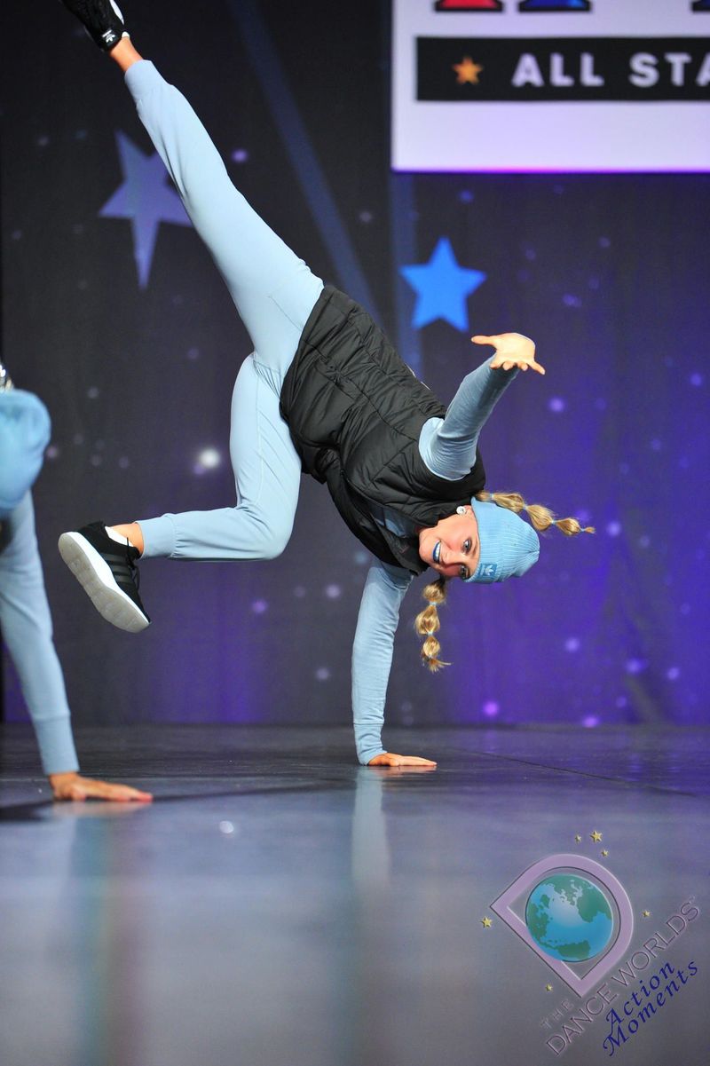 A person is doing a handstand on a stage.