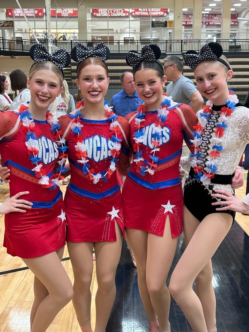 A group of cheerleaders are posing for a picture together