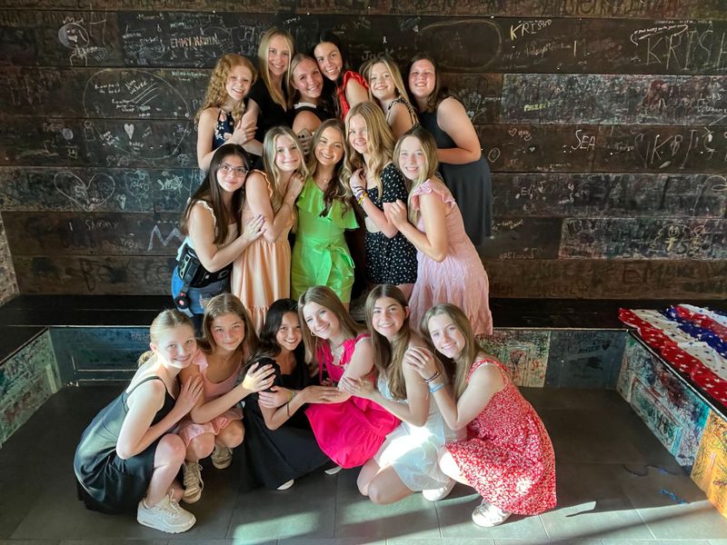 A group of young women are posing for a picture together.