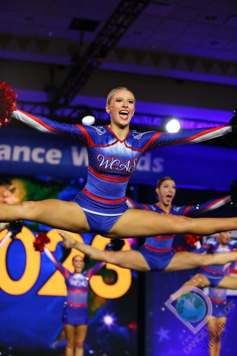 A cheerleader is doing a split in the air