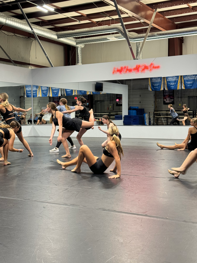 A group of young women are dancing in a dance studio.