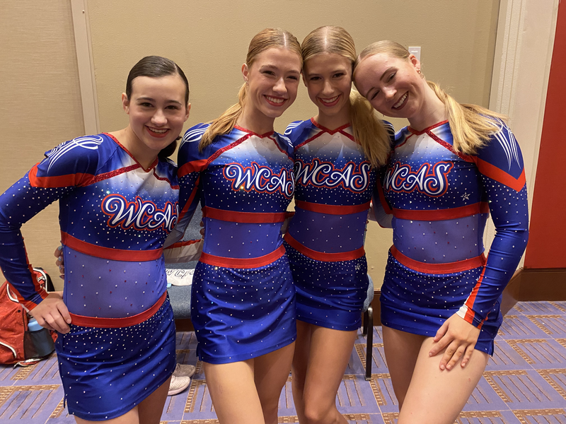 A group of cheerleaders are posing for a picture together
