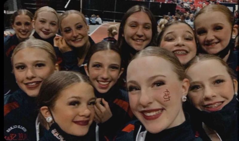 A group of young girls are posing for a selfie.