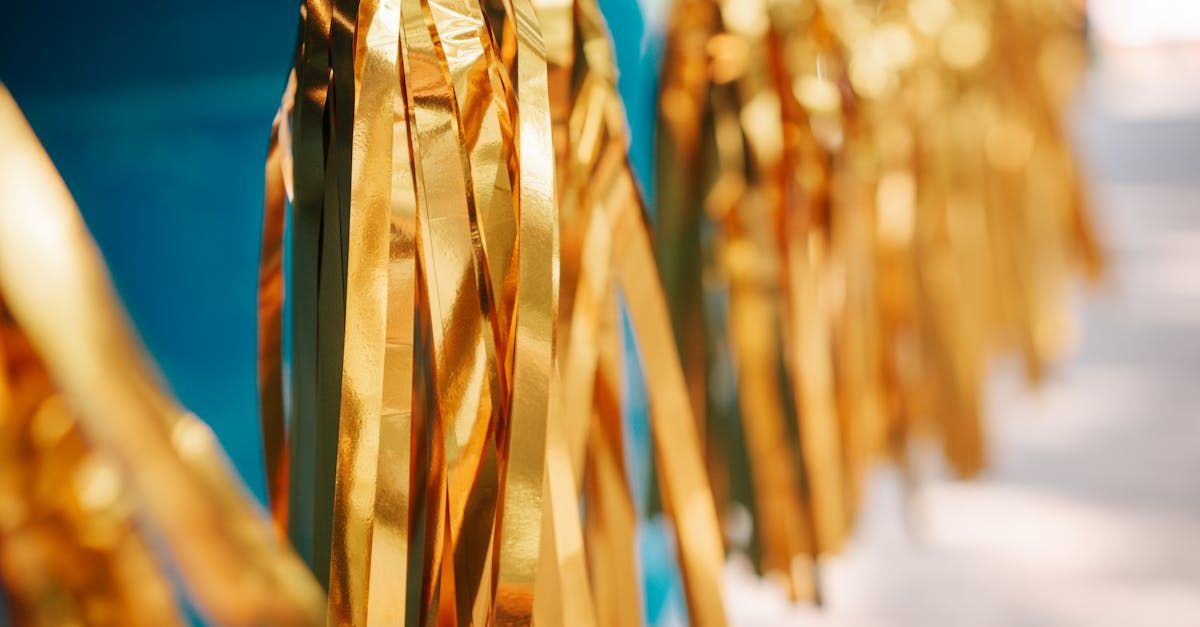 A close up of a row of gold tinsel on a blue background.