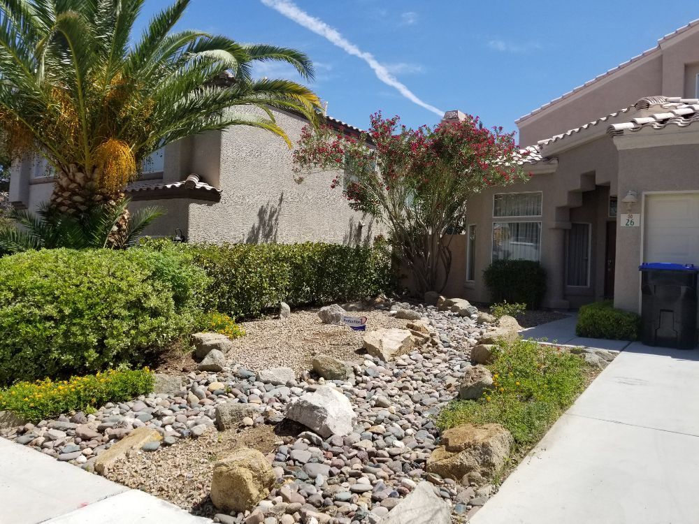 A house with a lot of rocks in front of it