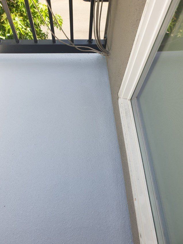 A close up of the final step to waterproof this deck in Los Angeles  CA.. The water-based, organic and hypo-allergenic sealer/color coat is applied and the deck is ready to meet  Mother Nature at her worst.
