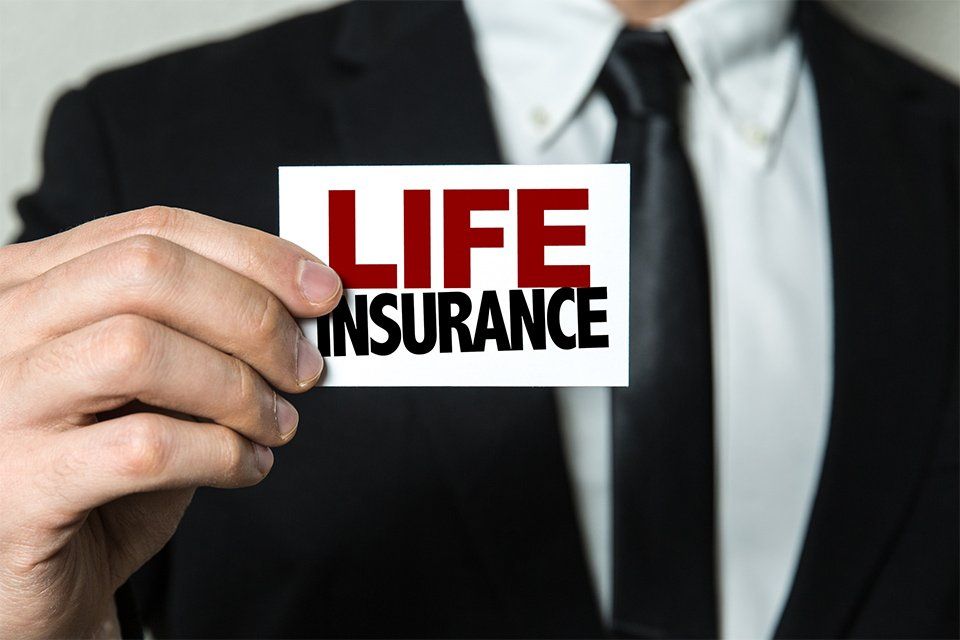 Insurance — Financial Adviser Holding Life Insurance Card in Atlanta, GA