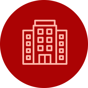 A light pink outline icon of a multi-story building set inside a solid red circle.