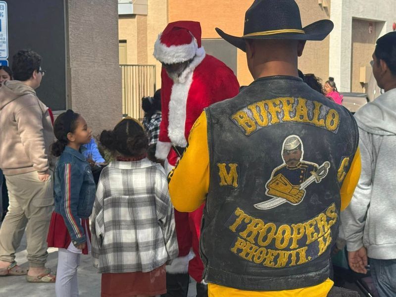 Santa with children and a biker wearing a 