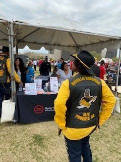 Person in a yellow jacket and black vest with 