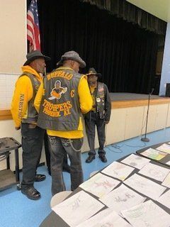 Three men in yellow and black vests with 