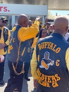 Group of people in yellow and navy vests; 