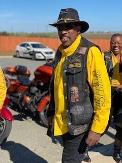 Man in yellow shirt and vest with 