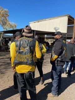 Group of people wearing yellow and black vests, 