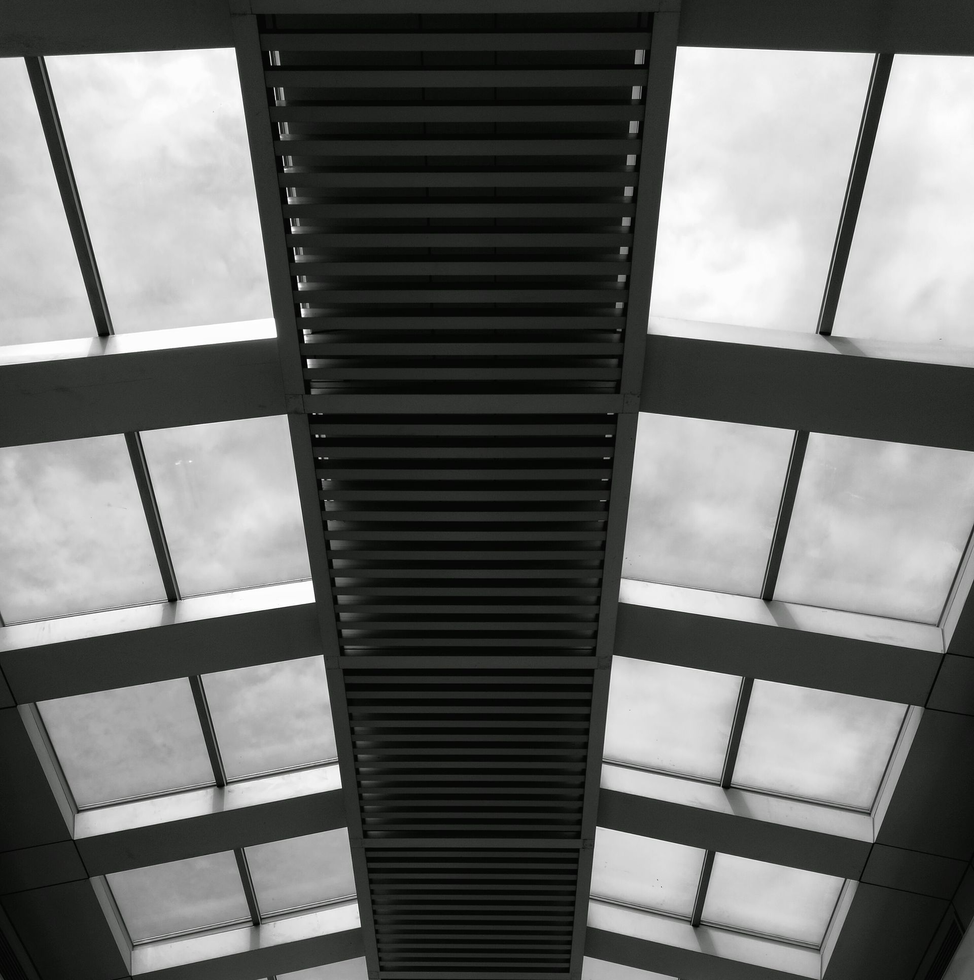 a black and white photo of a ceiling with lots of windows