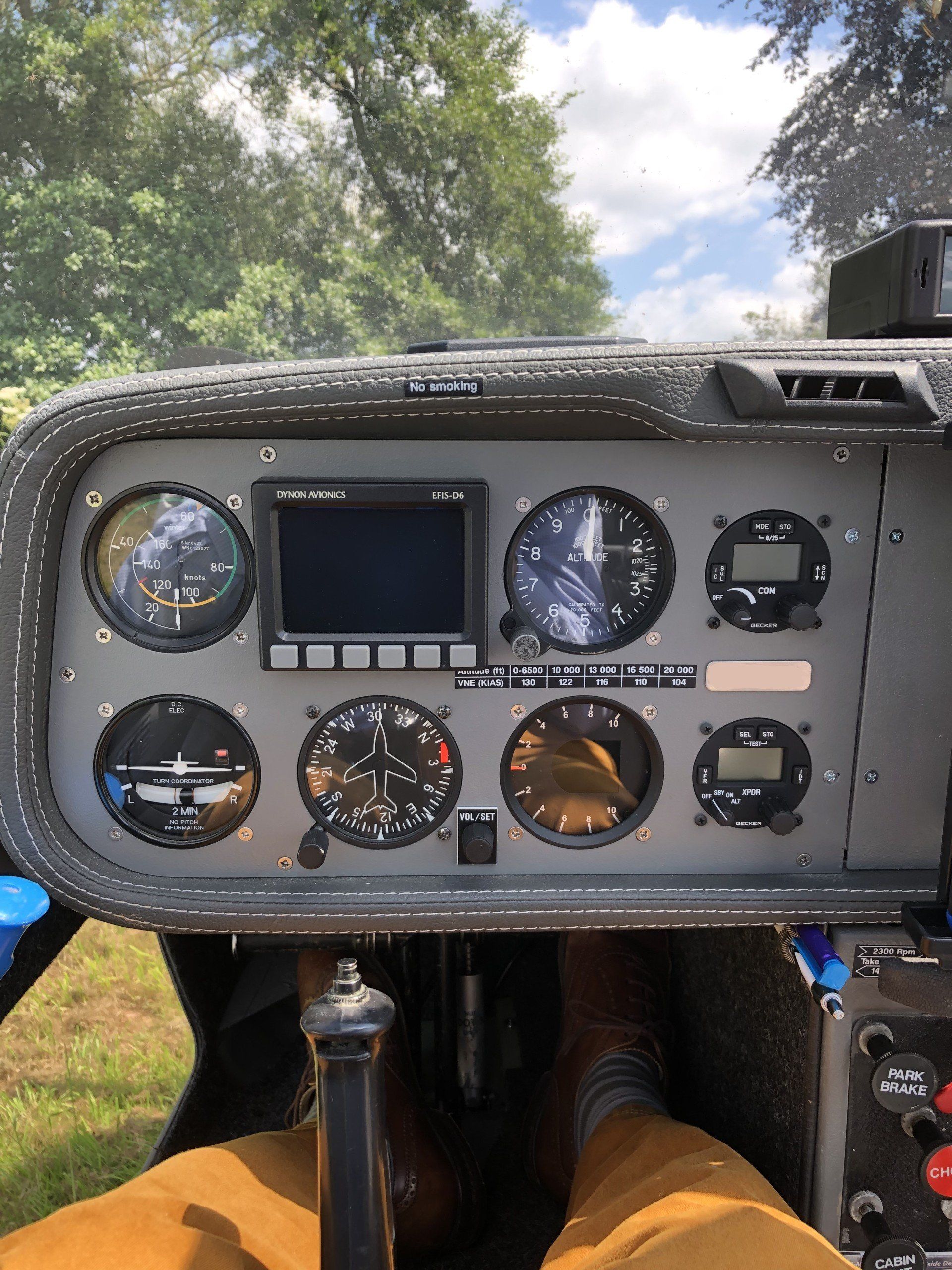 A person is sitting in the cockpit of a small plane
