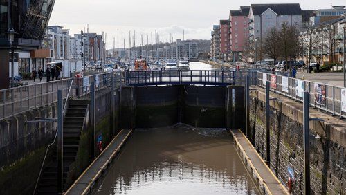 There is a bridge over a river in the middle of a city.