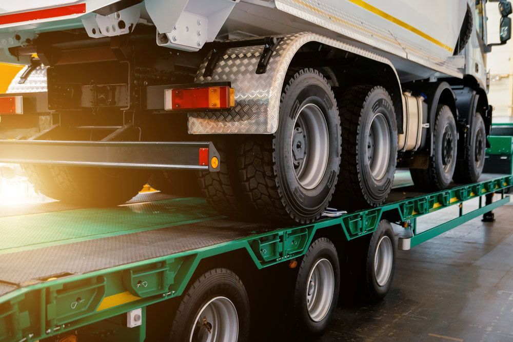 A Dump Truck Is Sitting On Top Of A Trailer — Gympie/Childers Towing Pty Ltd in Bundaberg, QLD